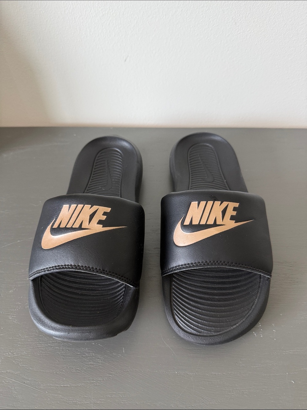 Nike Black Slides with Metallic Rose Gold Logo
